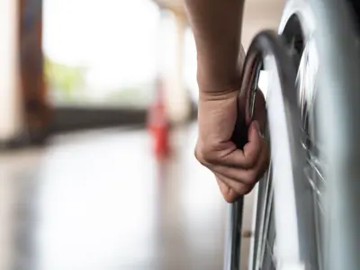 Hand on wheelchair wheel